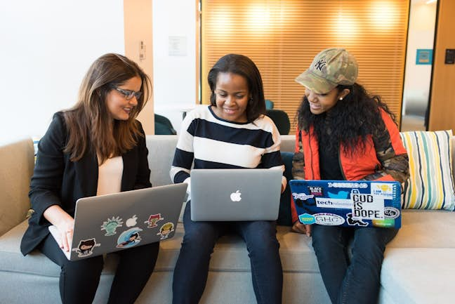 colleagues looking at laptops