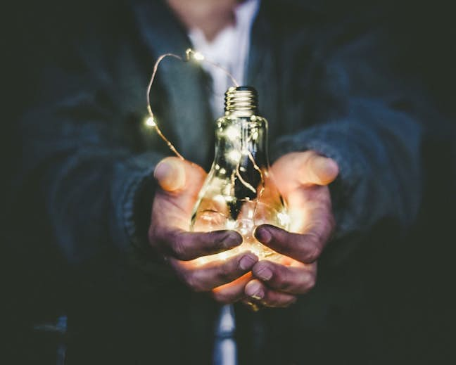 person holding lightbulb