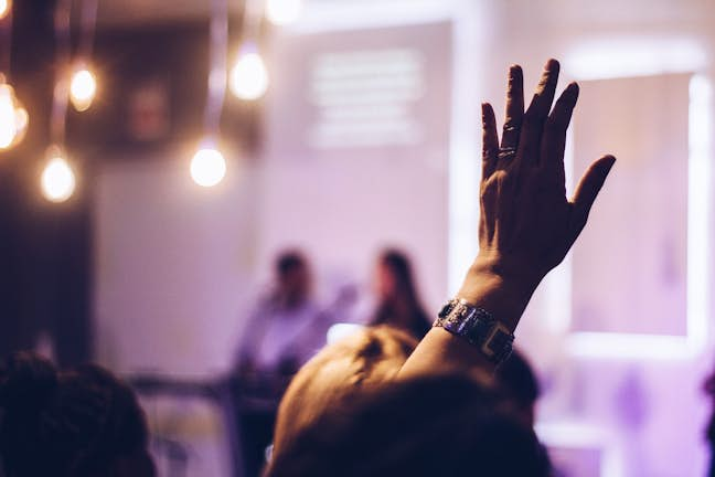 audience member with hand up