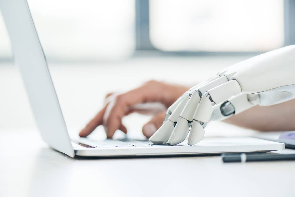 Human and AI robot on laptop