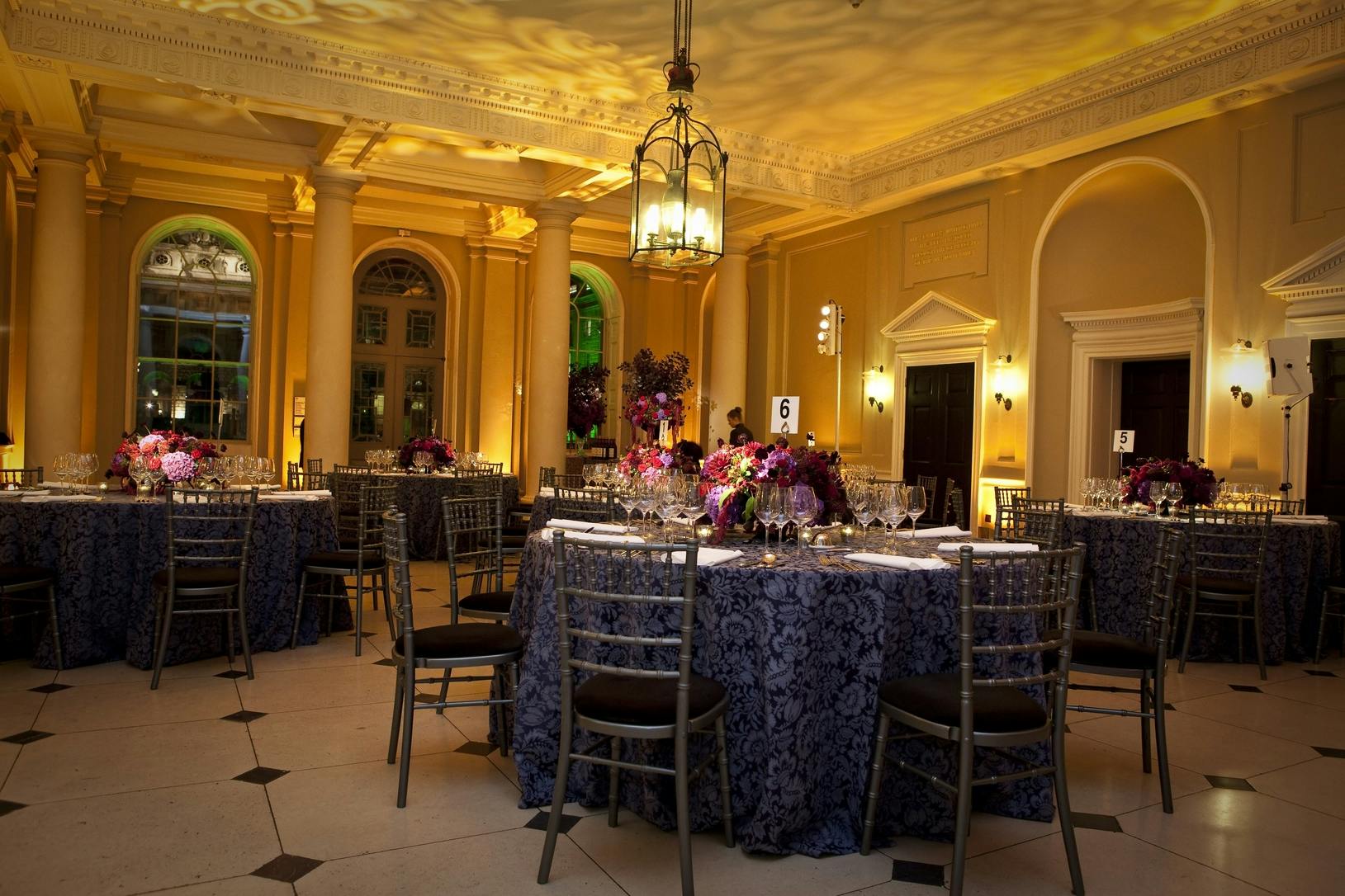 Elegant Seamen's Hall event space with blue tablecloths, ideal for formal dinners.