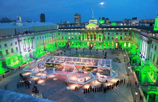 Edmond J. Safra Fountain Court with green lighting, ideal for upscale events and receptions.