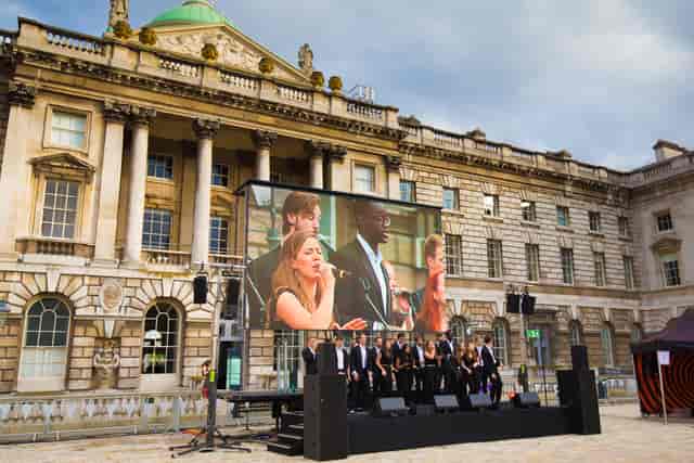 Edmond J. Safra Fountain Court event setup with large screen for corporate presentations.