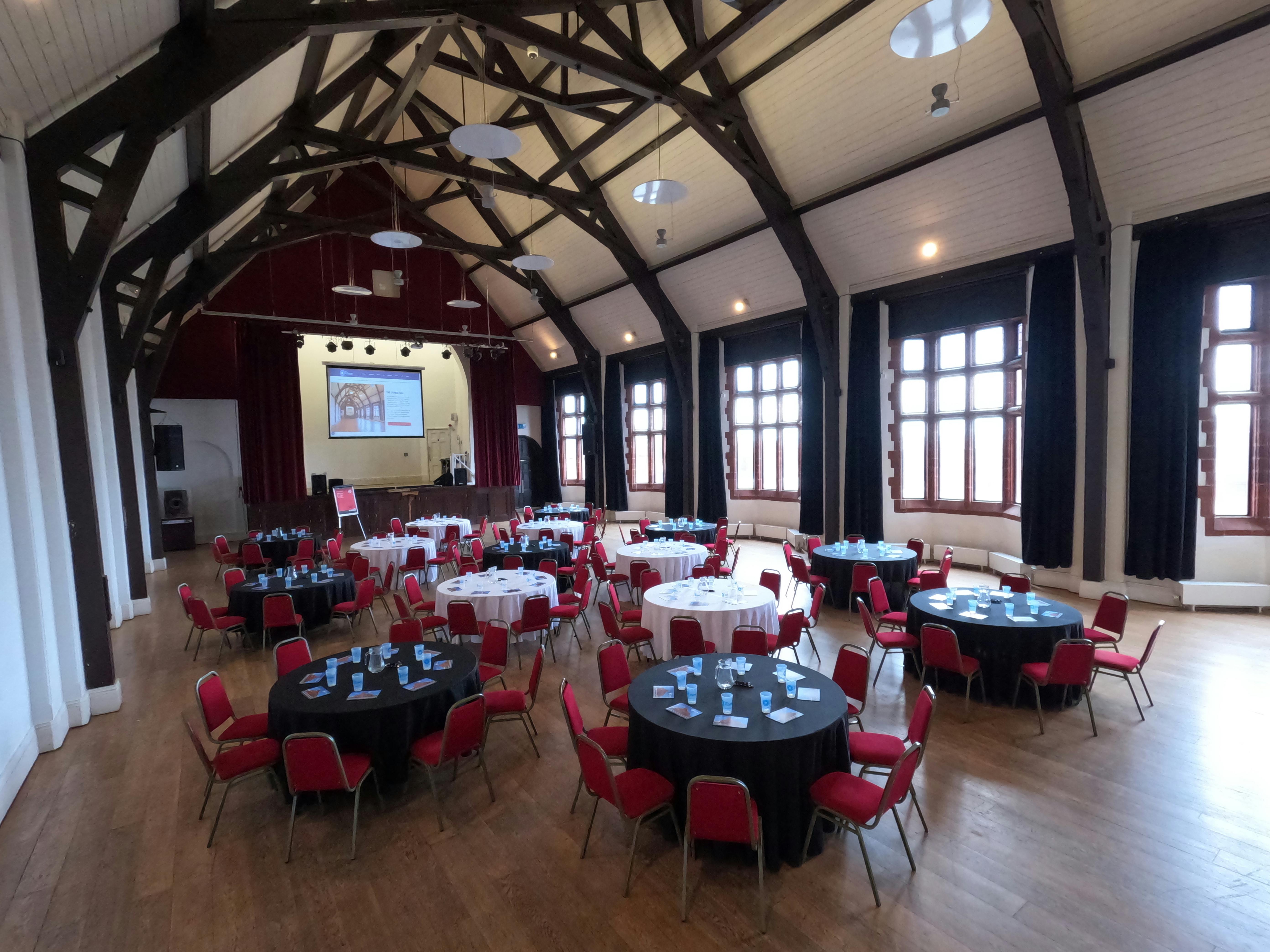 Spacious event venue with round tables, ideal for meetings and banquets at The Florrie.