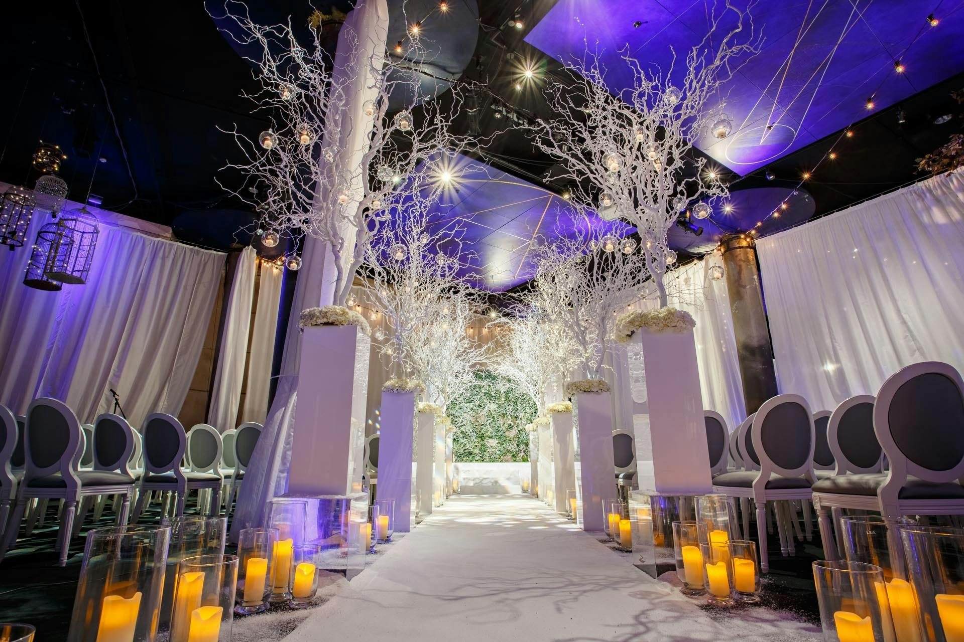 Underglobe event space with white trees, ideal for weddings and formal gatherings.