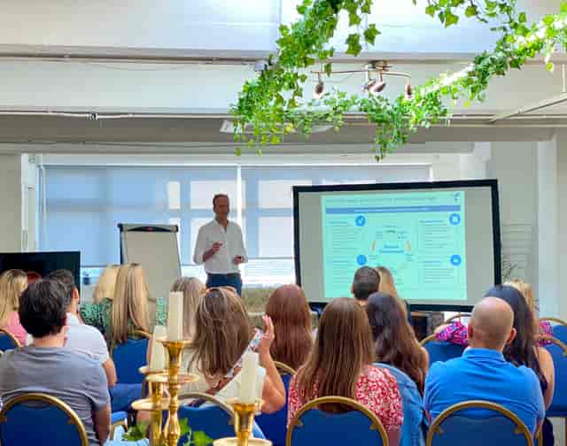 4th Floor Studios meeting space with presenter, large screen, ideal for workshops and events.