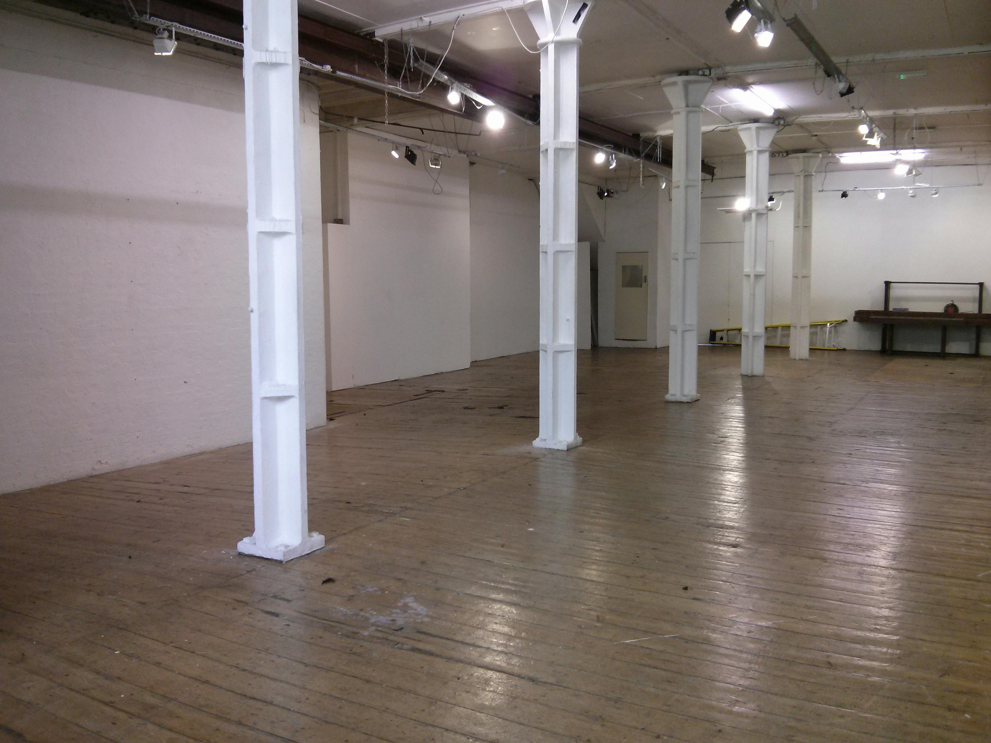 Spacious Ground Floor Gallery venue with wooden flooring for events and workshops.