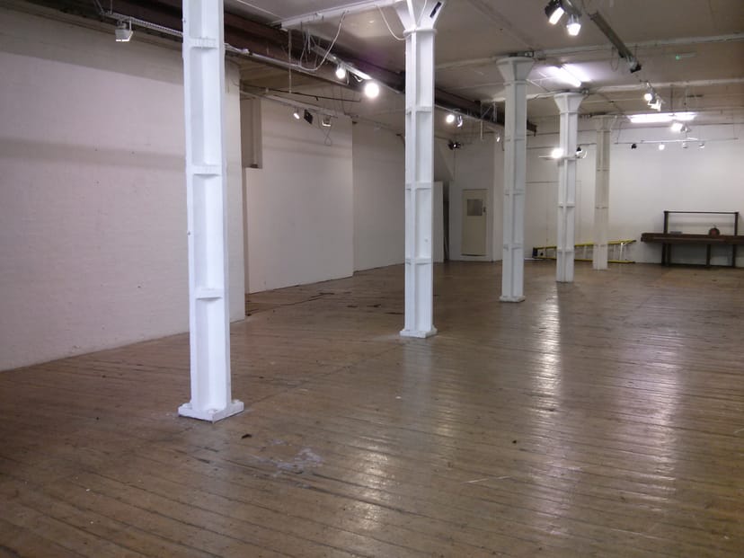 Spacious Ground Floor Gallery venue with wooden flooring for events and workshops.