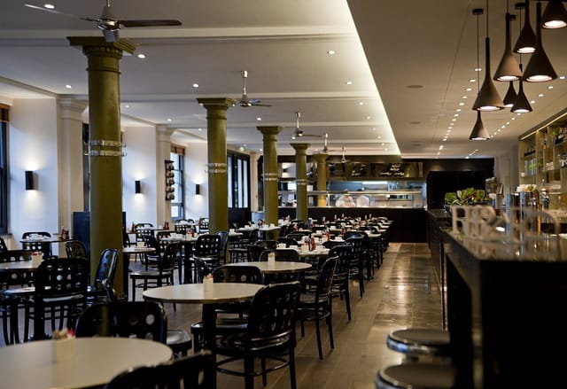 Eastway Restaurant dining area with round tables, perfect for events and meetings.