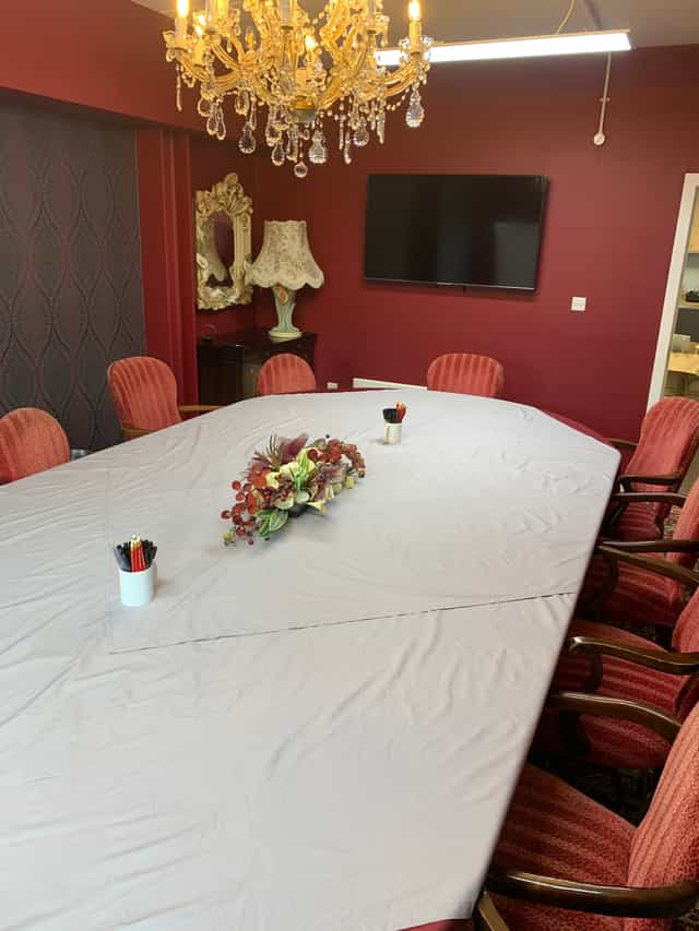 Elegant conference room with oval table, ideal for meetings and events.