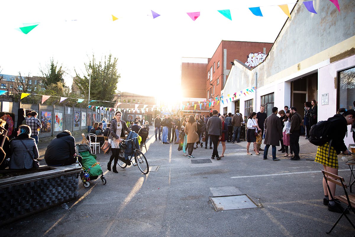 Vibrant outdoor market with colorful bunting, ideal for gatherings and networking events.