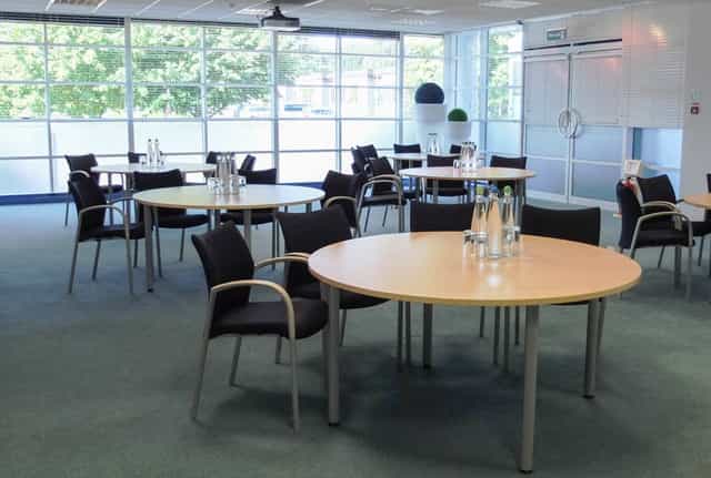 Andaman meeting space with round tables, ideal for workshops and networking events.