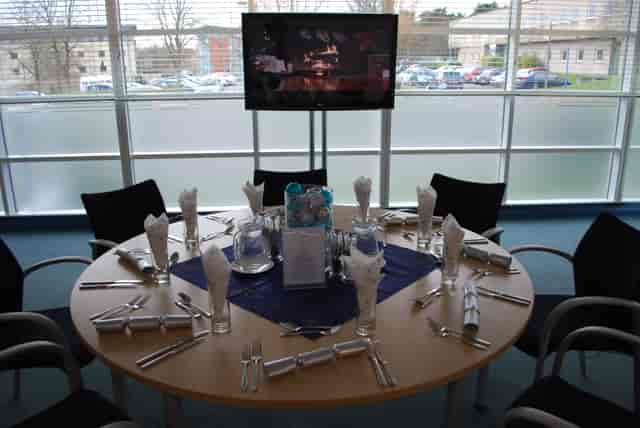 Round table set for a formal event at The Ark Conference Centre, featuring elegant decor.