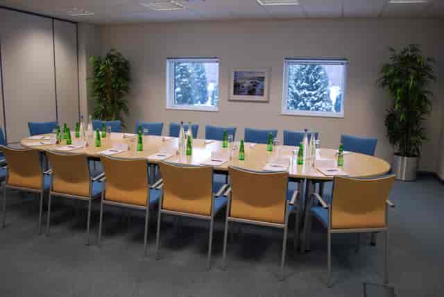Lugano meeting room with oval table, ready for professional conference and discussions.