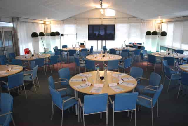 Pavilion at The Ark Conference Centre, modern meeting space with round tables for conferences.