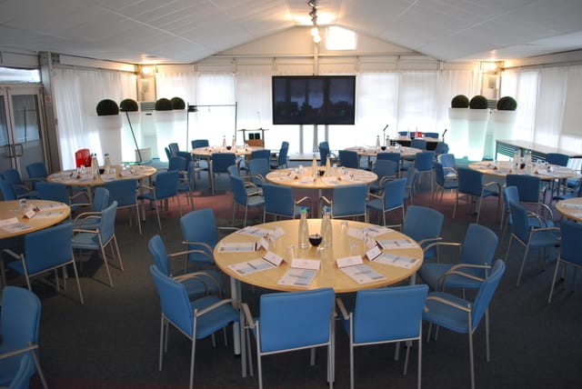Pavilion at The Ark Conference Centre, modern meeting space with round tables for conferences.