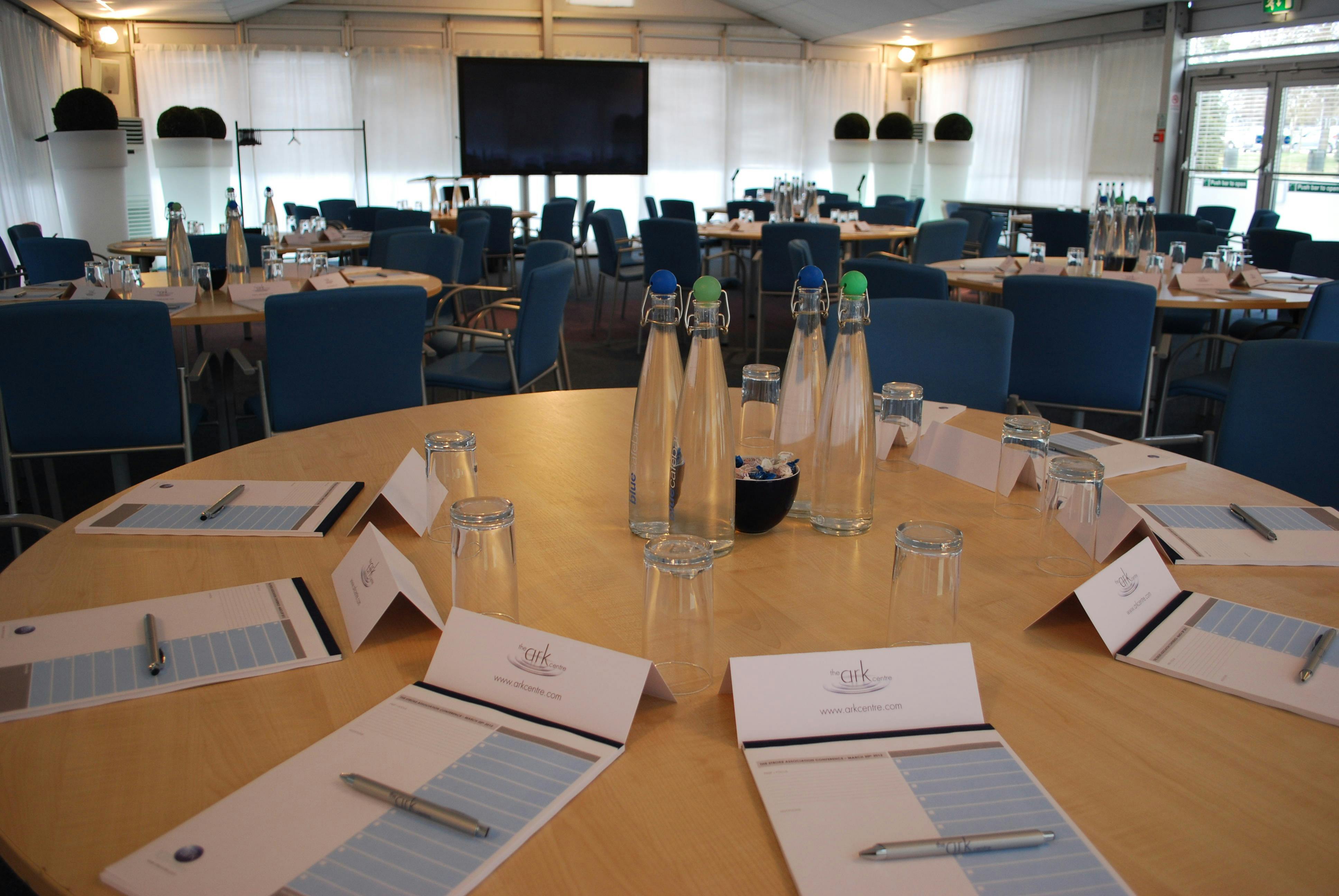 Pavilion at The Ark Conference Centre: bright meeting space with round tables for collaboration.