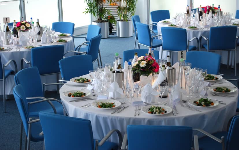 Elegant event space at The Ark Conference Centre with round tables and floral centerpieces.