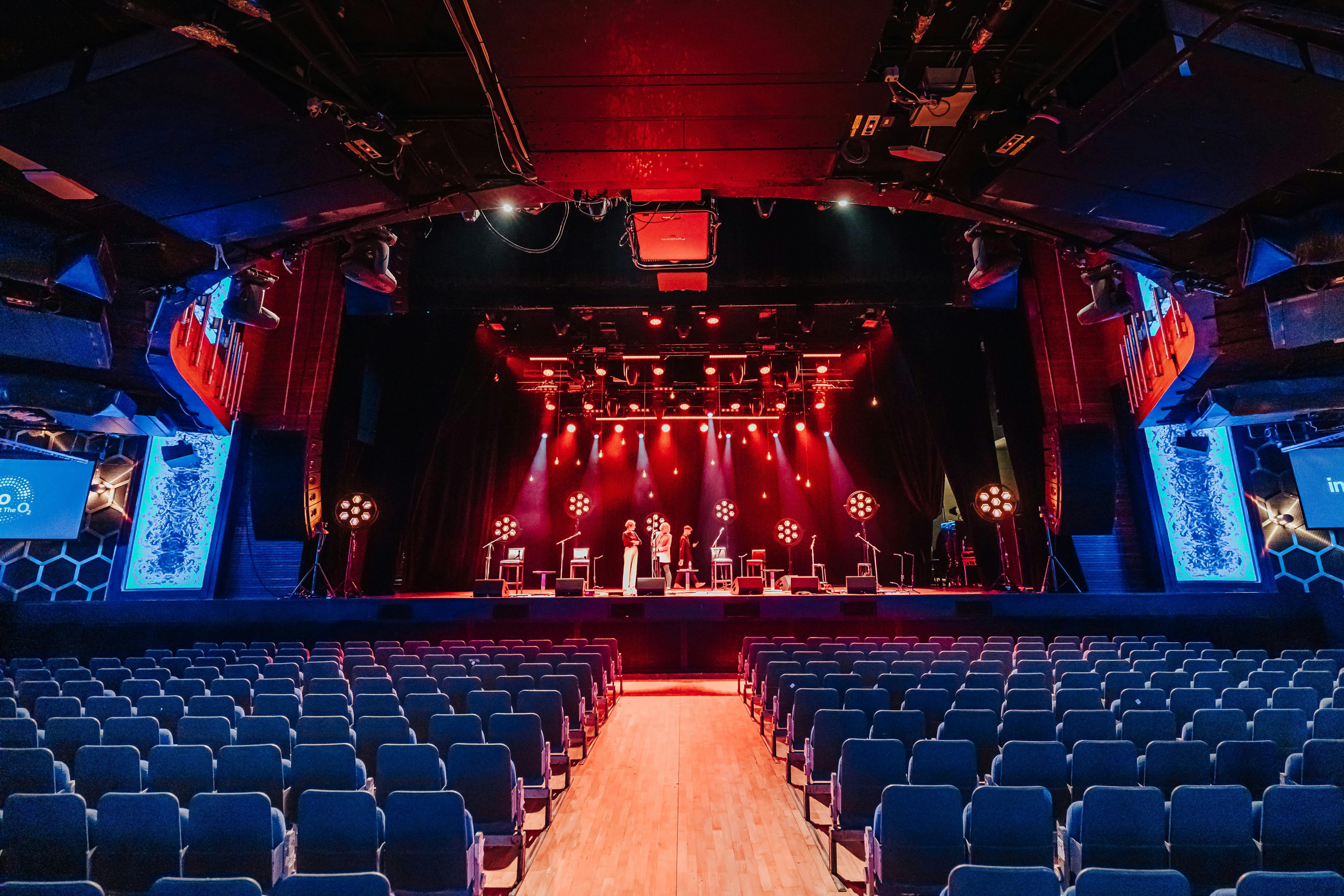 Main Area at The O2 with vibrant stage lighting for conferences and performances.