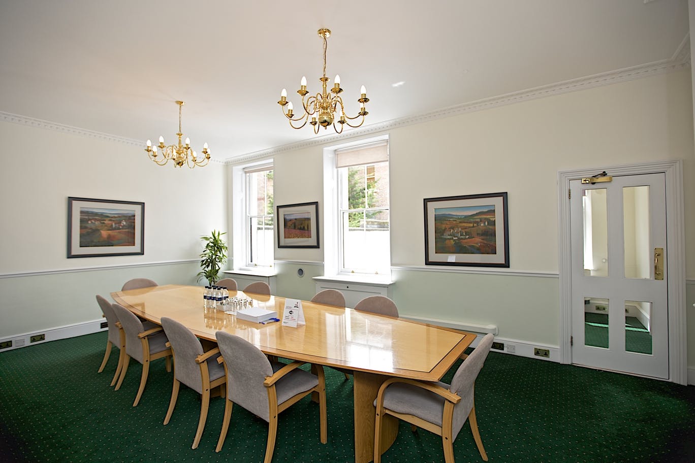 Lytton Strachey Room with wooden table, ideal for corporate meetings and events.