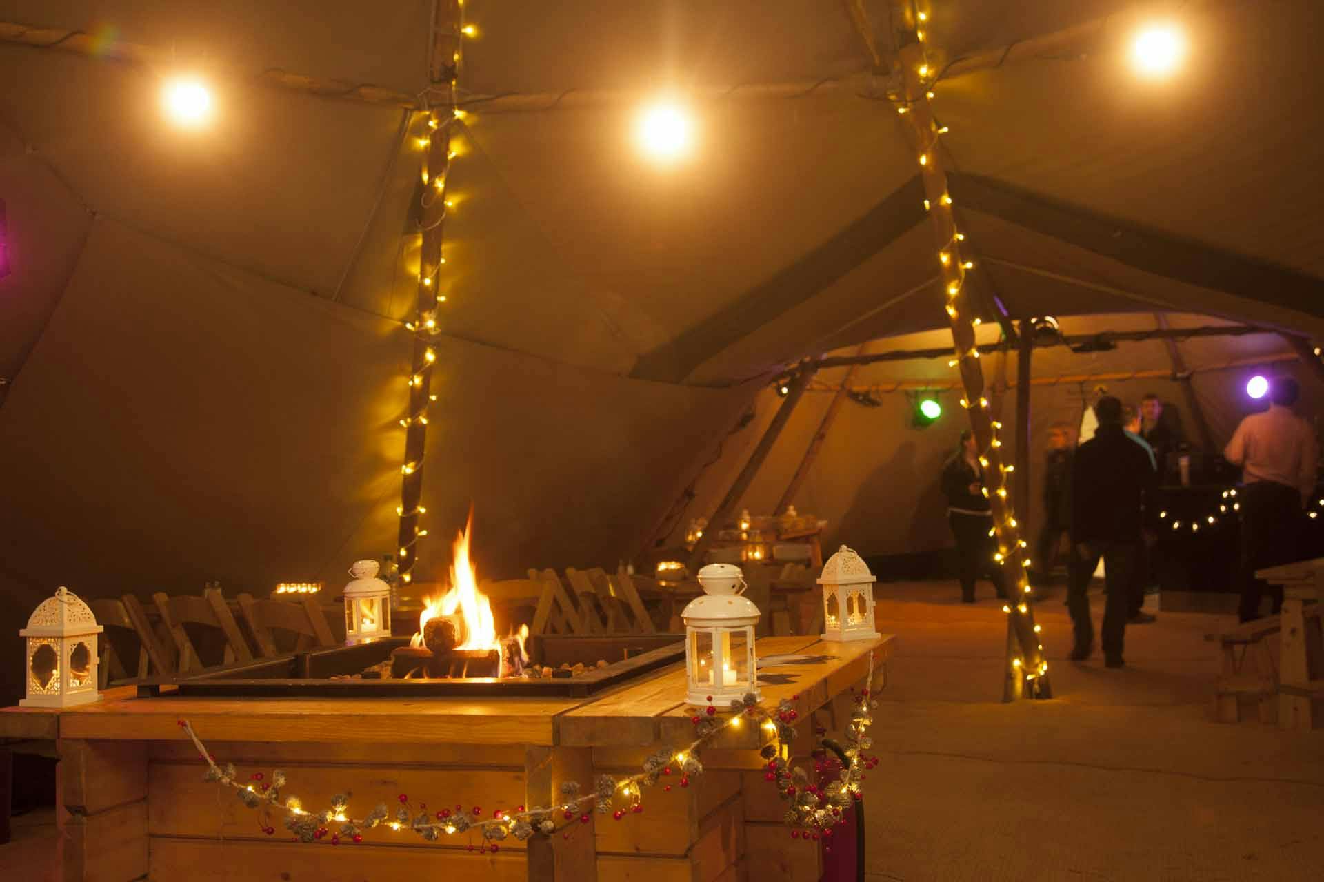 Cozy Forest Tepee event space with lanterns, perfect for gatherings in Forest of Dean.