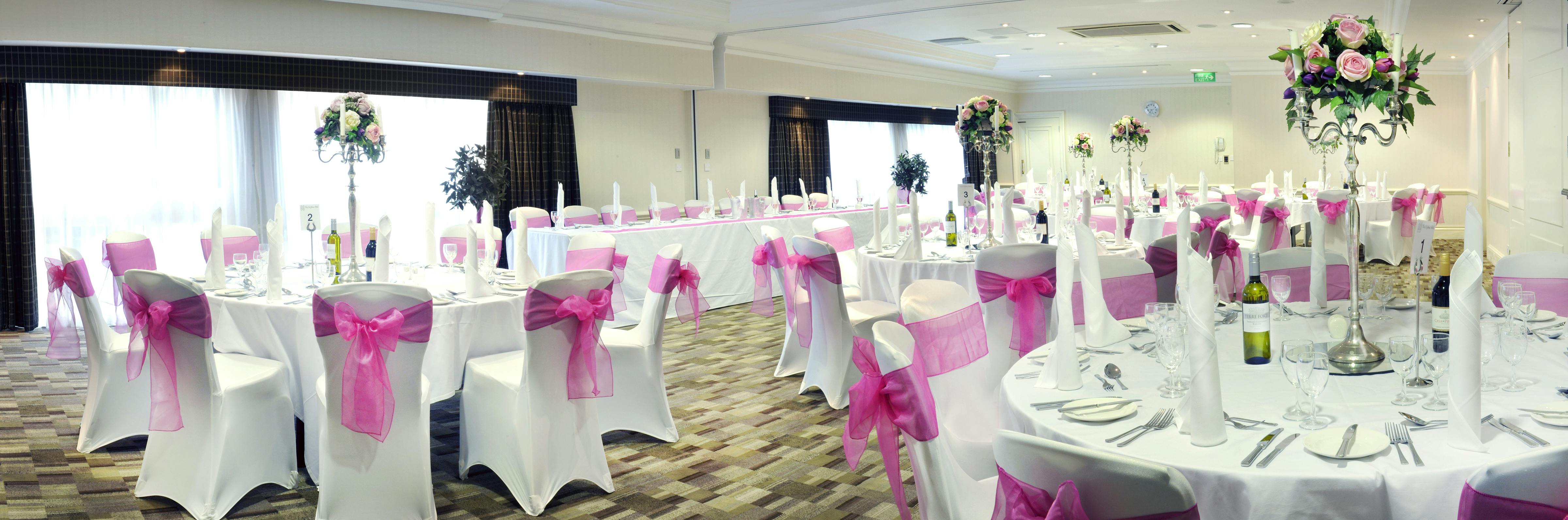 Gloucester Suite at St Johns Hotel: elegant wedding venue with pink accents and floral decor.