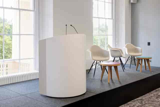Modern stage setup in Prince Philip House for corporate panel discussions and presentations.