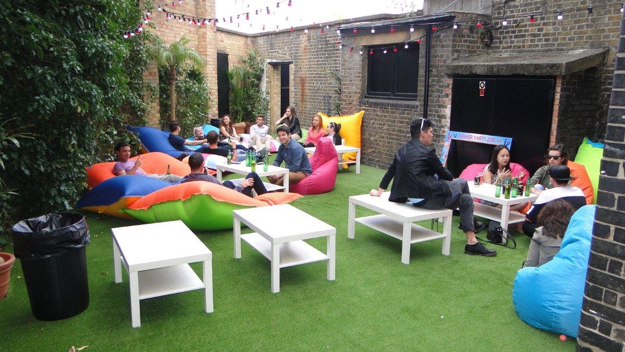 Vibrant outdoor lounge with bean bags for summer networking and team-building events.