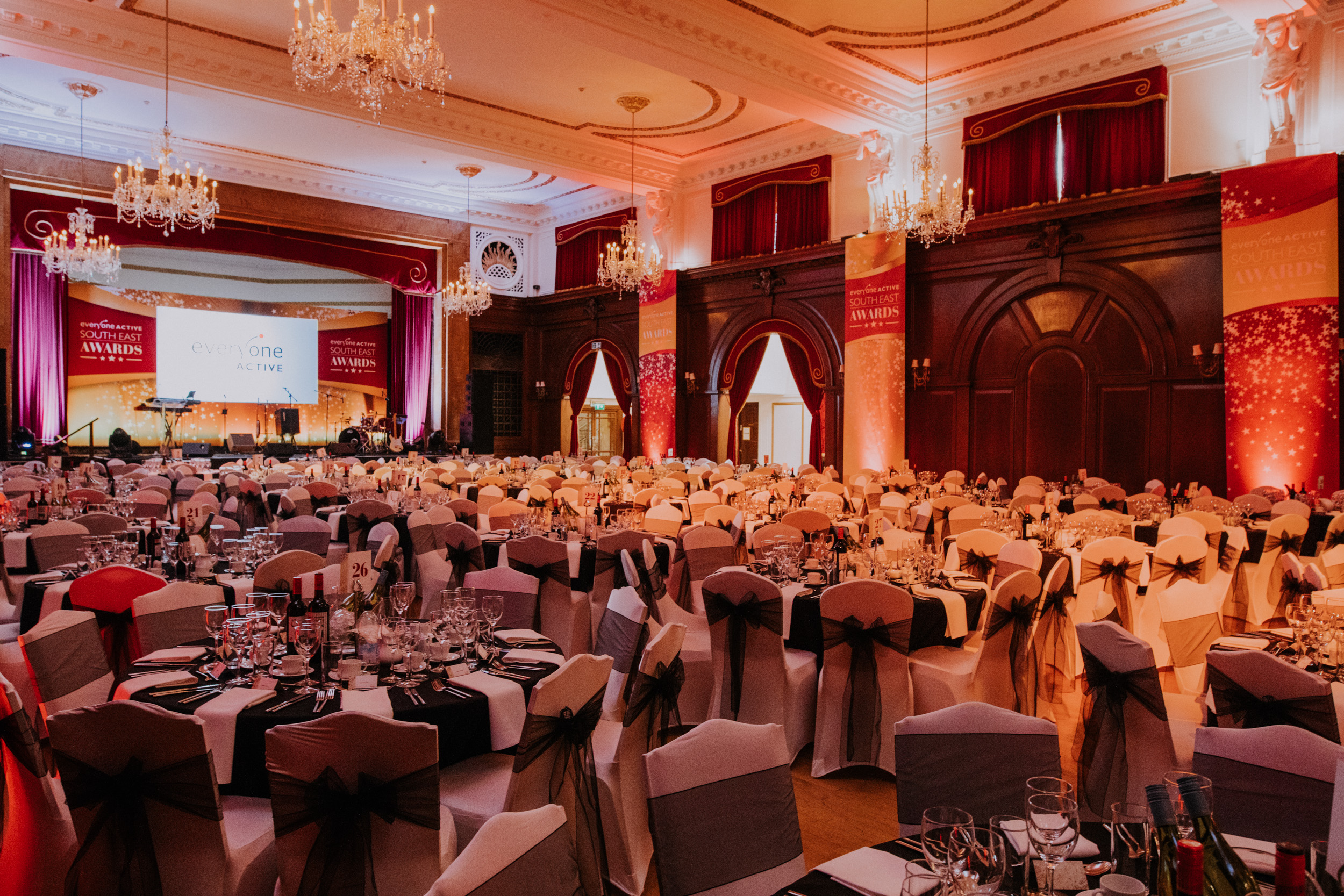 Elegant banquet hall with black and gold decor for corporate events and galas. - Banner