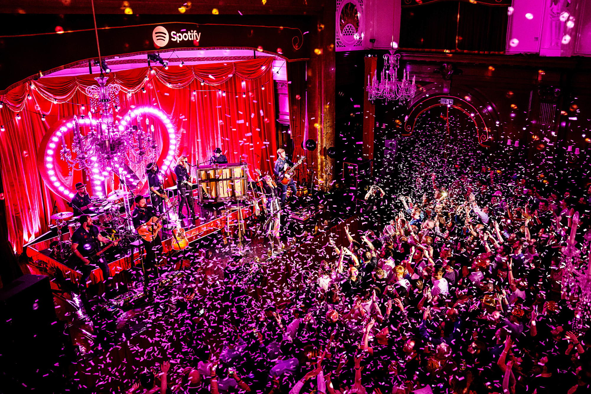 Porchester Hall Main Hall with live band, confetti, and vibrant corporate event atmosphere. - Banner