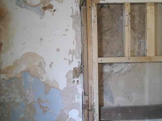 Partially renovated Safehouse 1 with peeling paint, ideal for events and meetings.