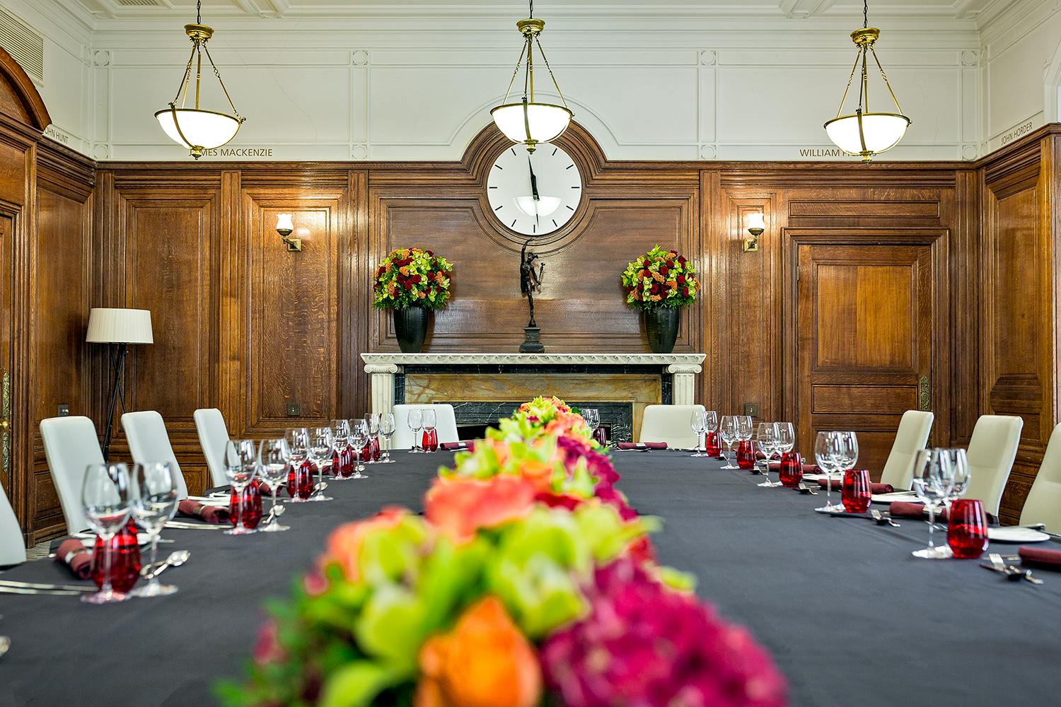 Elegant meeting room with floral centerpieces for corporate events at The Heritage Rooms.