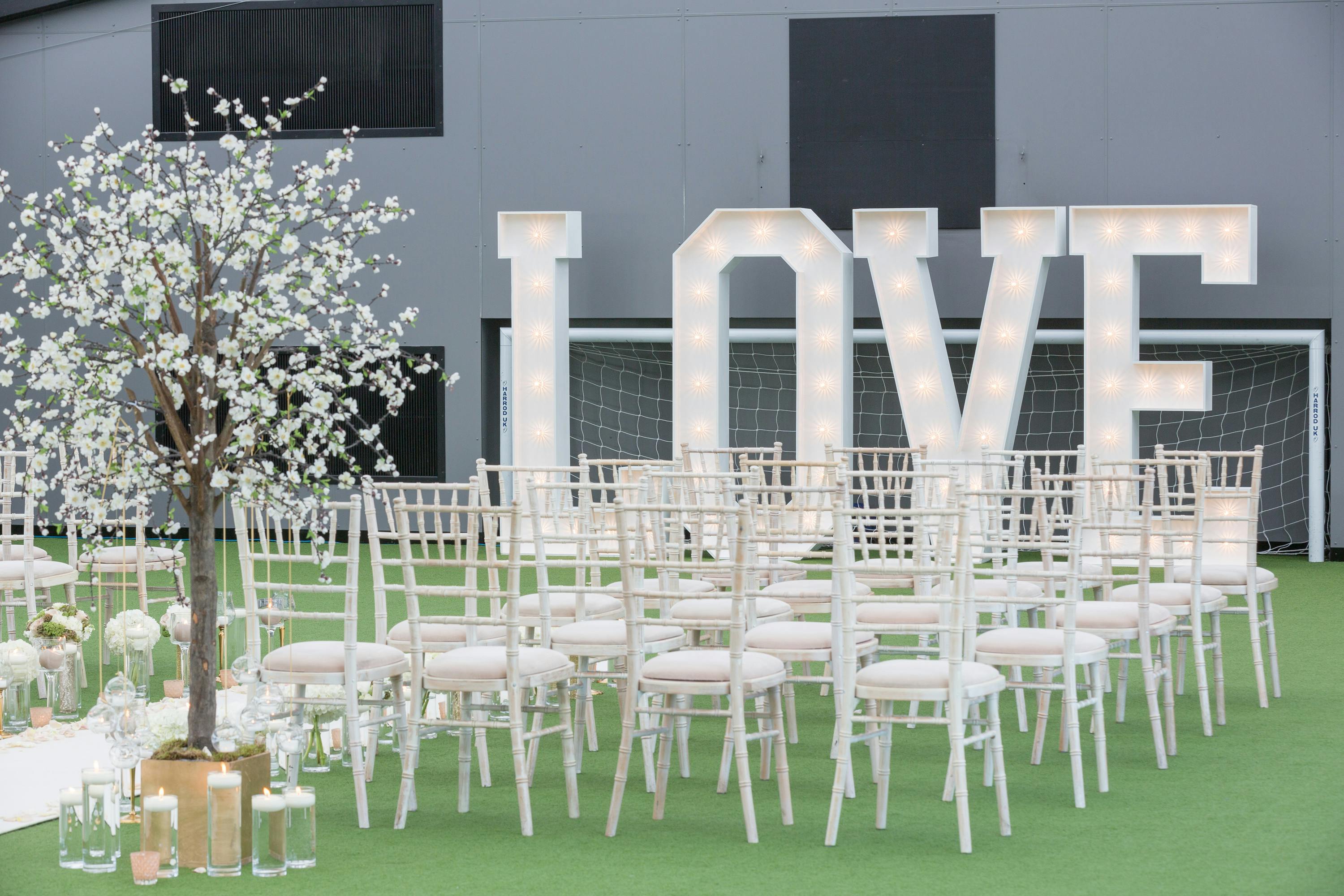 Heaven at Hotel Football with illuminated "LOVE" sign, ideal for weddings and events.