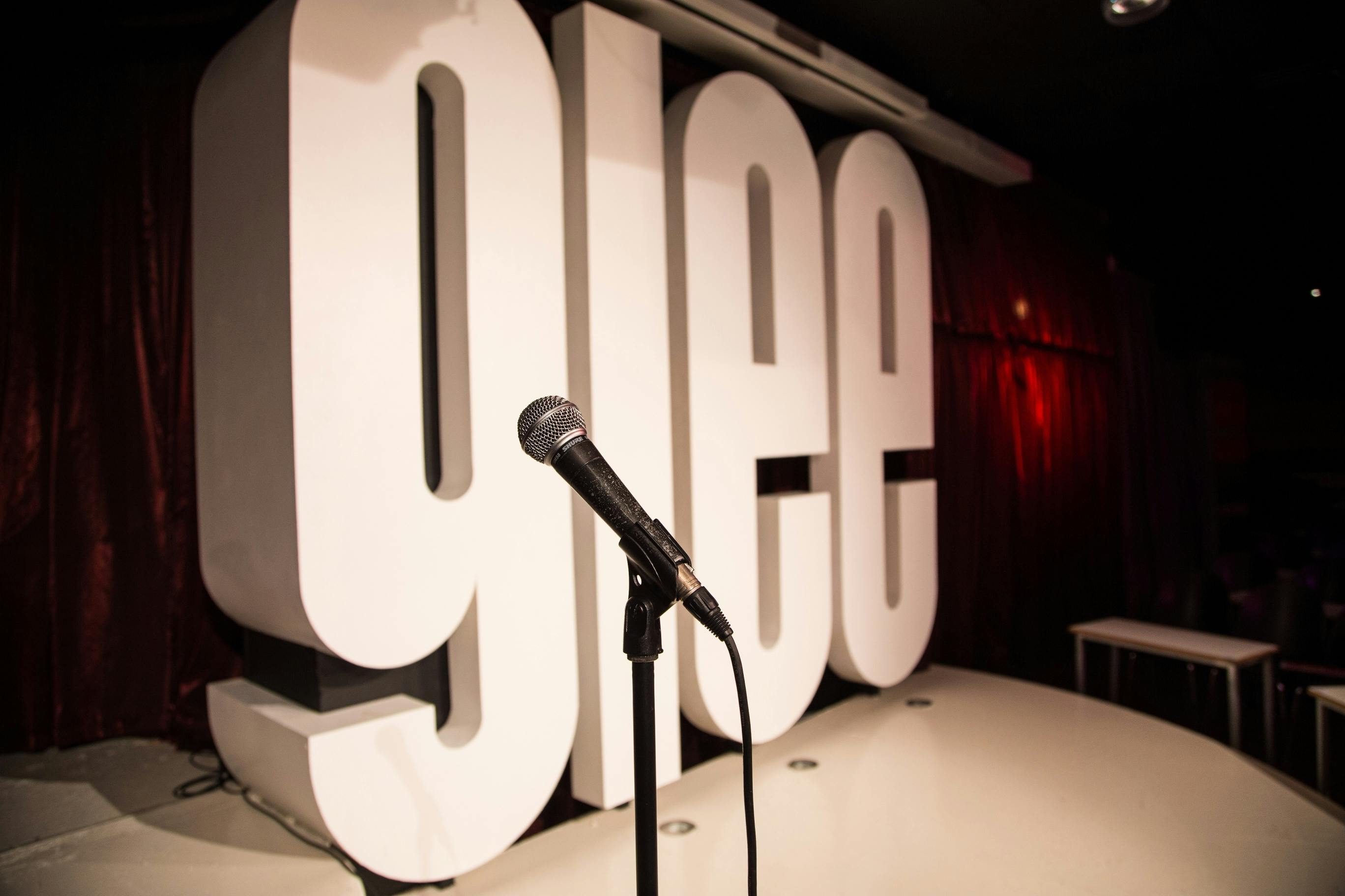 Vibrant Glee Club Birmingham stage with "glee" sign, perfect for comedy and talent events.