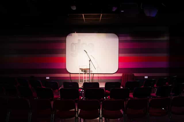 Intimate stage setup with microphone for presentations in Glee Club Birmingham.