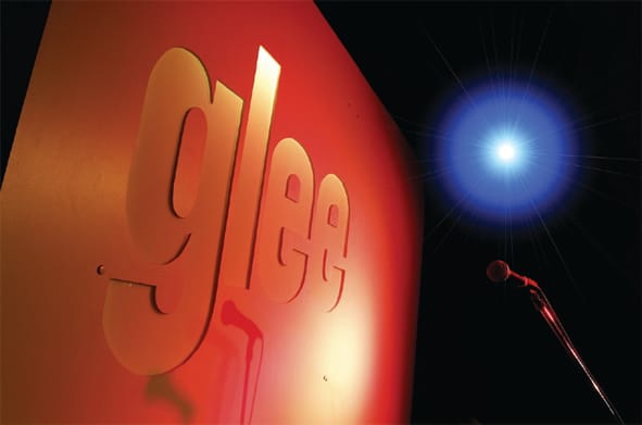 Vibrant "glee" stage backdrop in Birmingham for live performances and events.