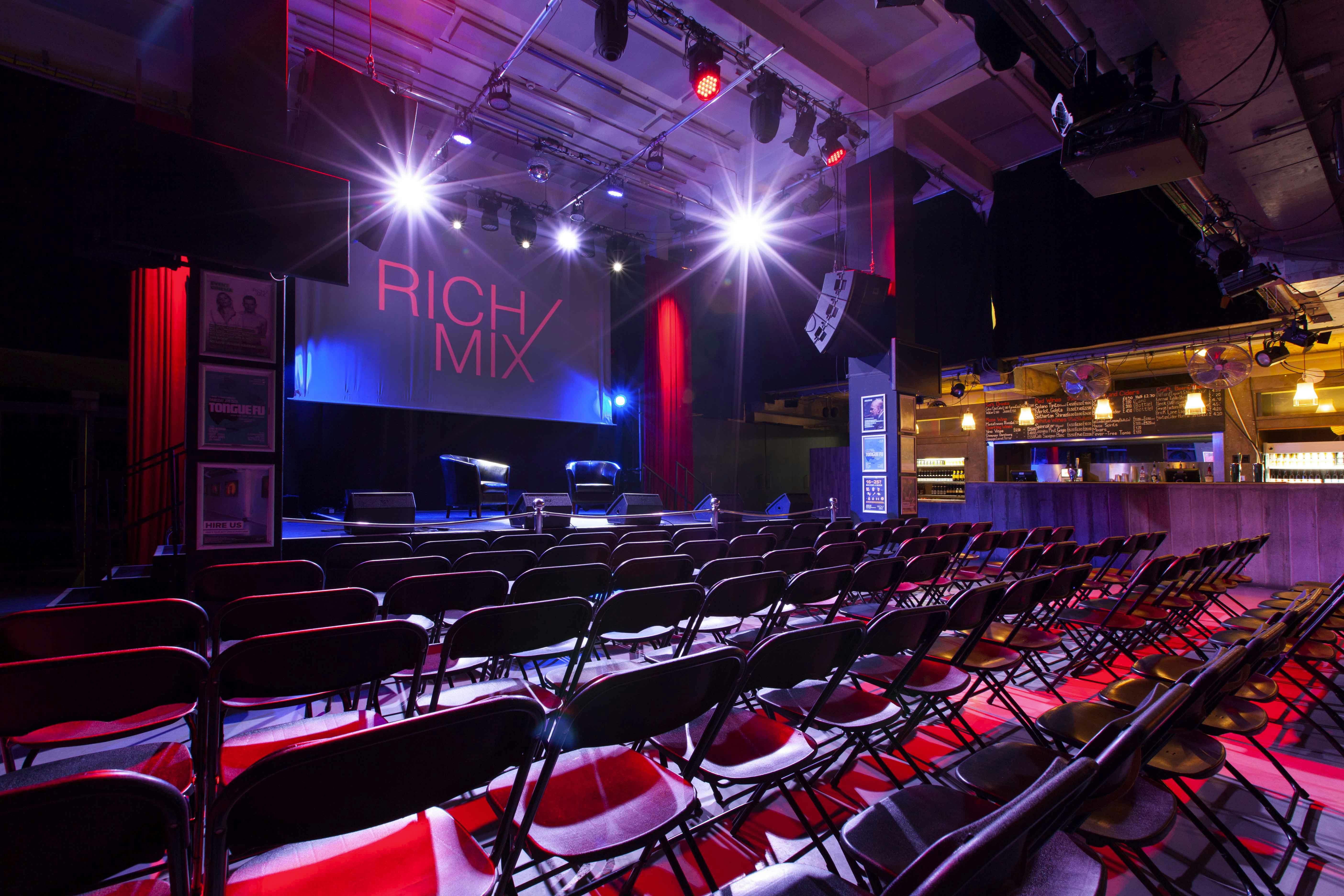 Event space at Rich Mix with stage lighting, ideal for presentations and networking.