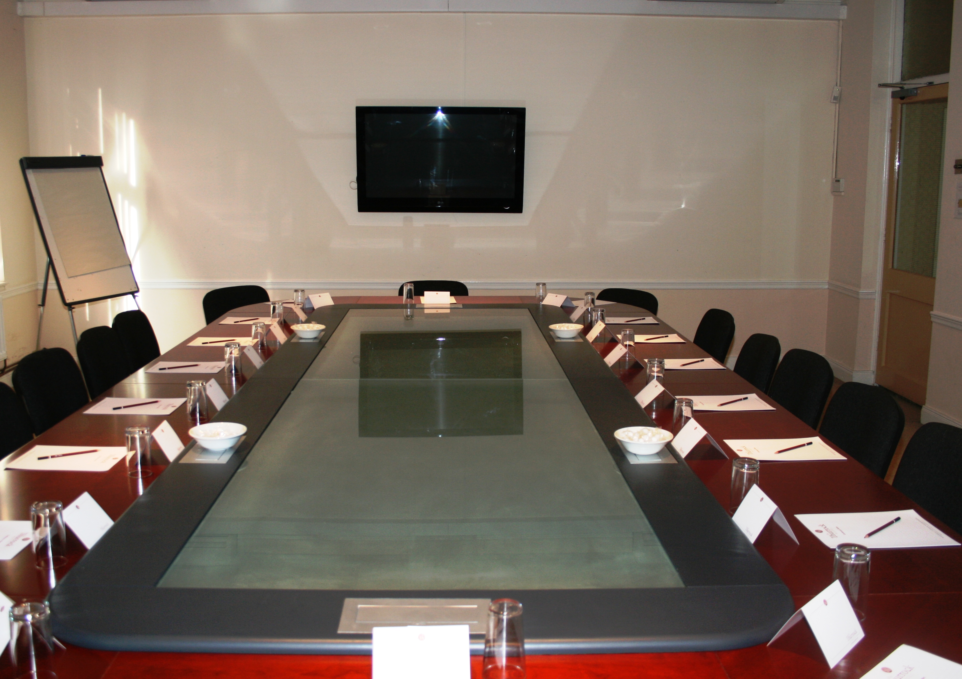Conference room at Best Western Thurrock Hotel with modern glass table, ideal for meetings.