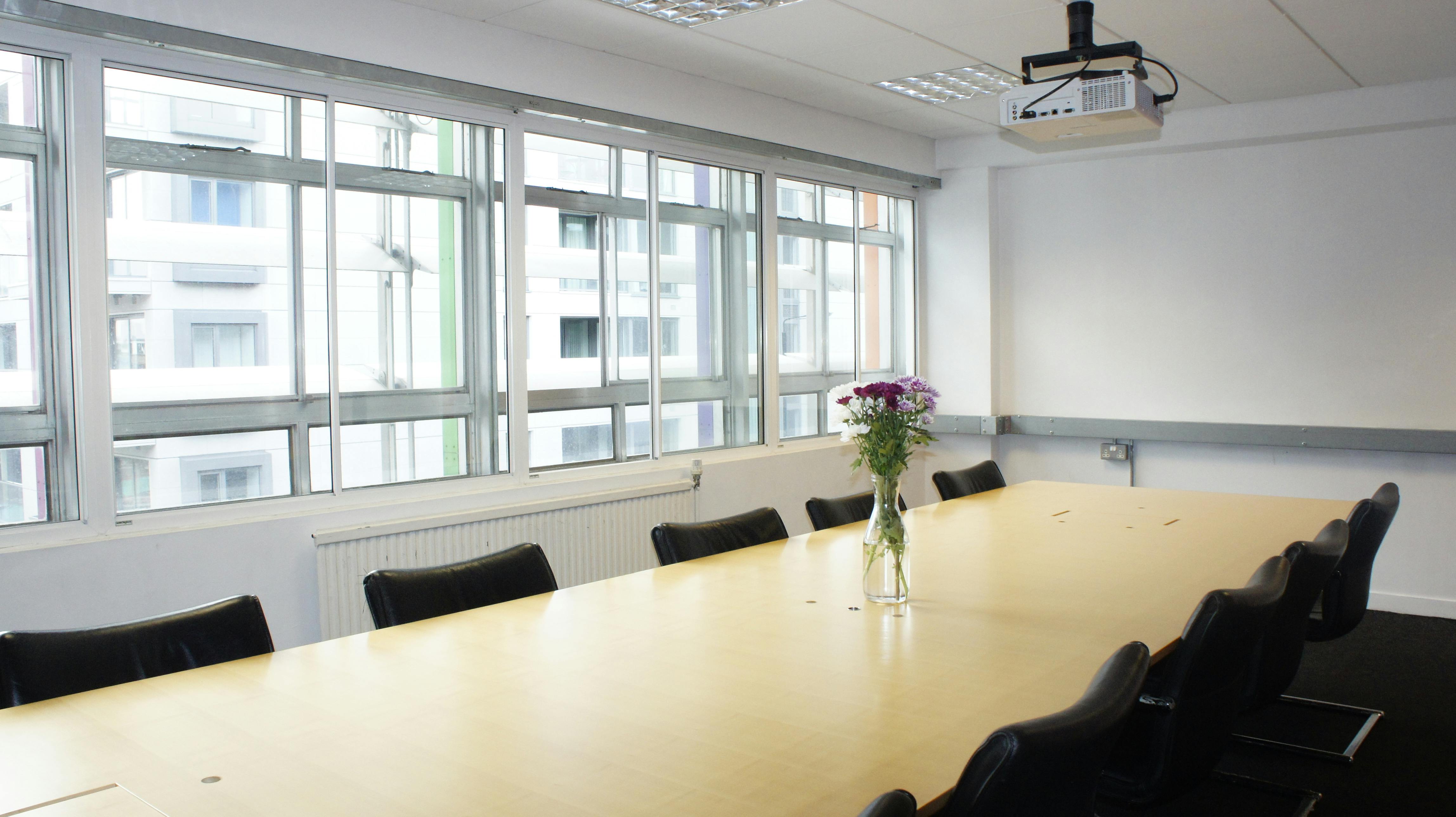 Boardroom in Rich Mix with wooden table, ideal for meetings and presentations.