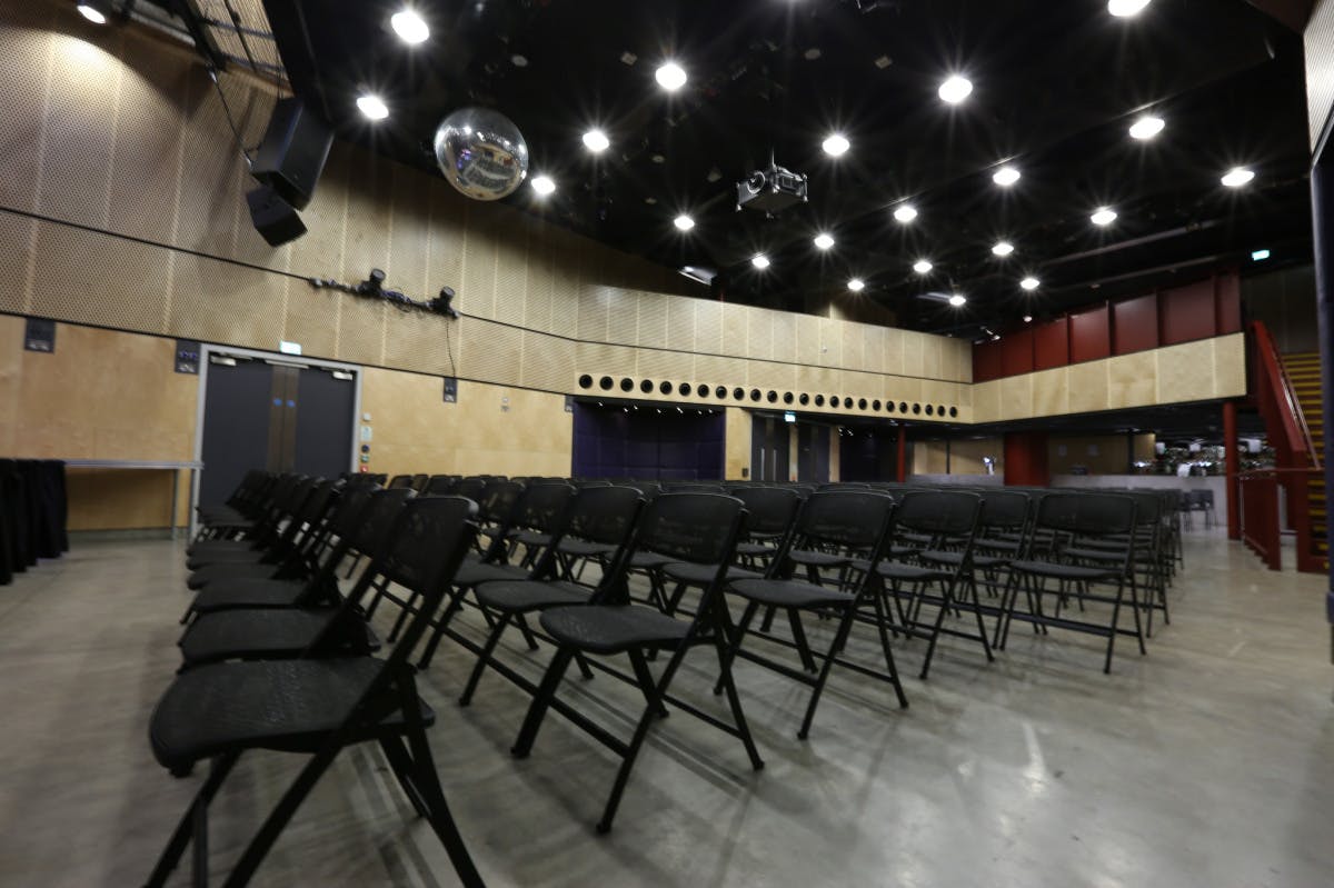 Main Venue in Saw Swee Hock Centre with black chairs, ideal for workshops and parties.