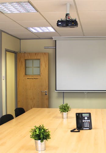 Meeting room with projector screen for professional gatherings and workshops.