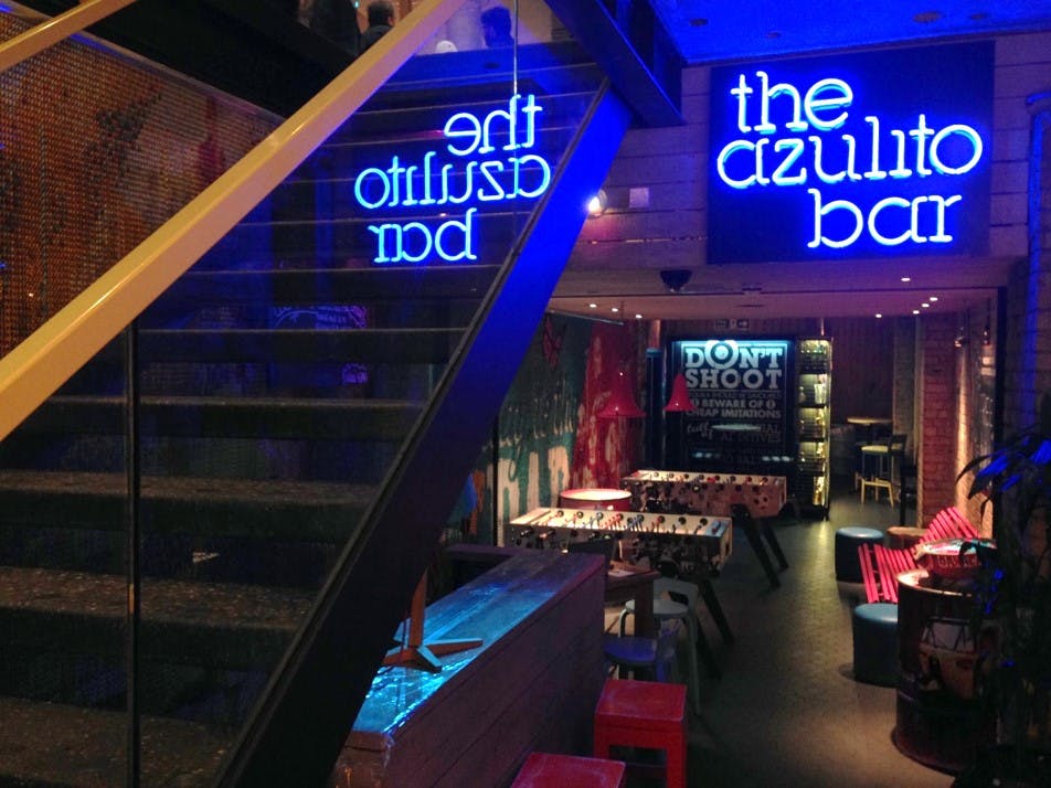 Vibrant Azulito Bar with neon signage, ideal for networking events and gatherings.