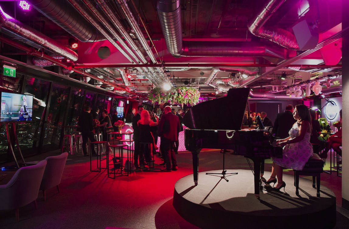 Whole Venue at Landing 42 with grand piano, ideal for upscale events and networking.