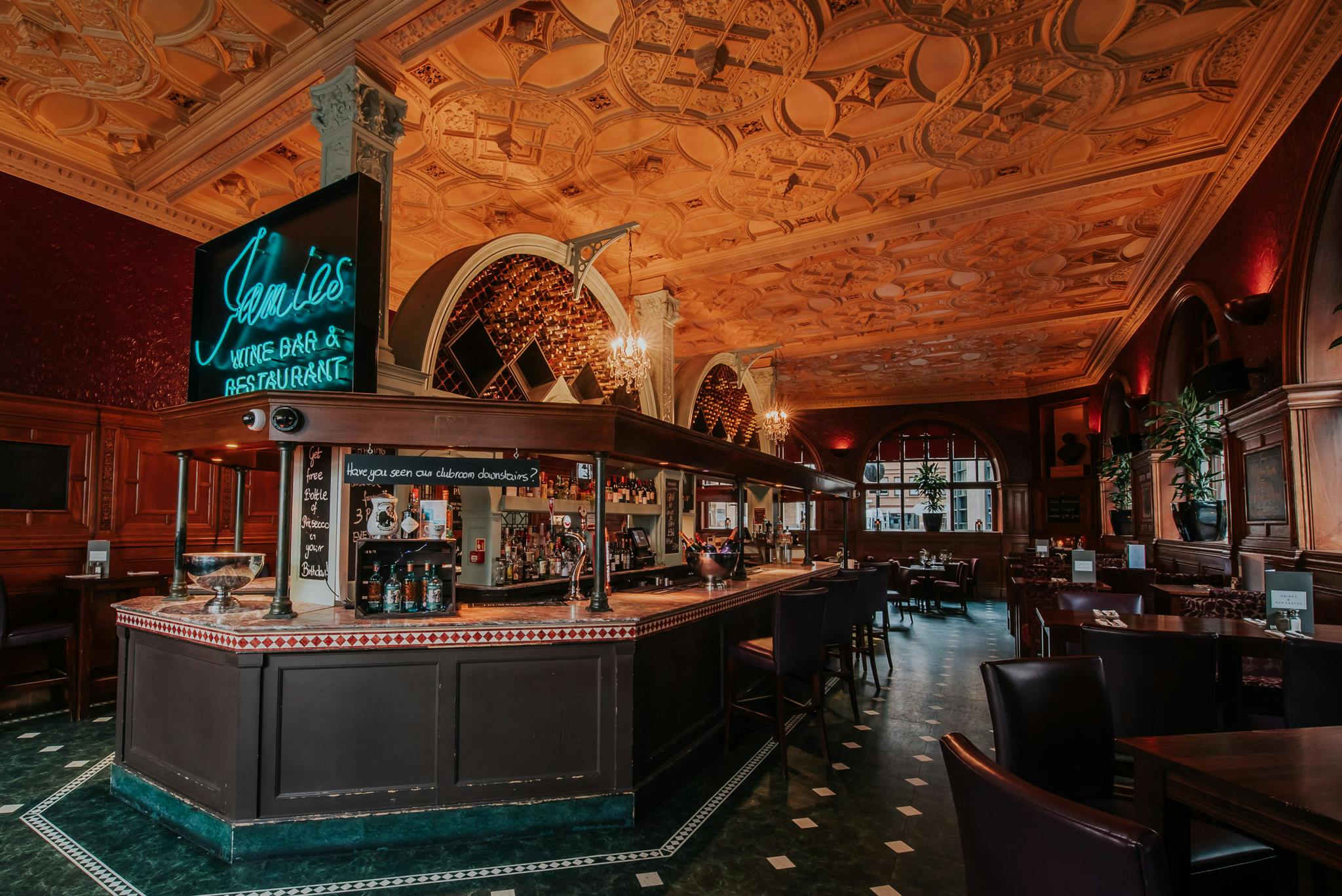 Sophisticated bar venue with ornate ceiling for cocktail receptions and private dinners.