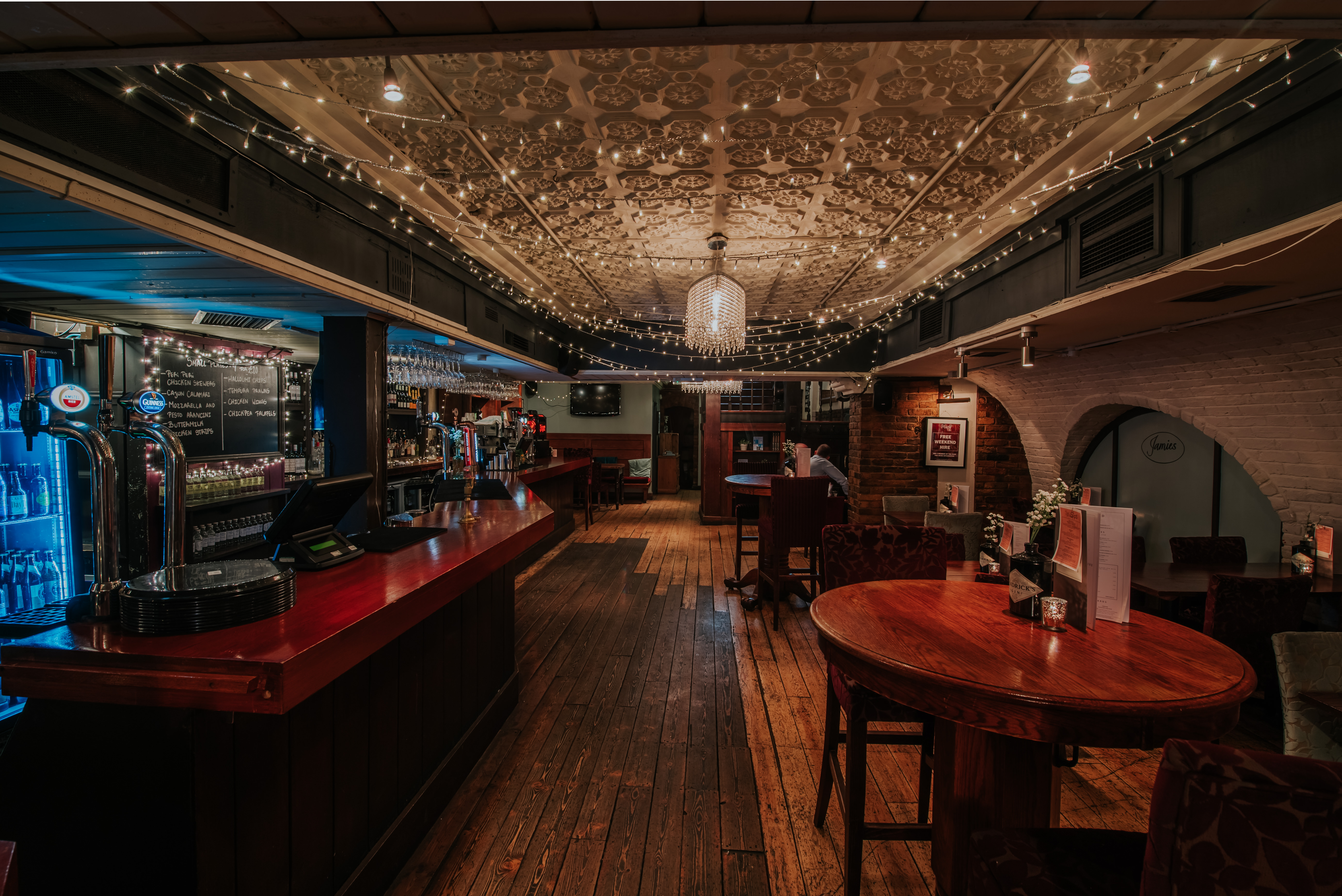 Charming venue with elegant lighting, ideal for intimate gatherings and networking events. - Banner