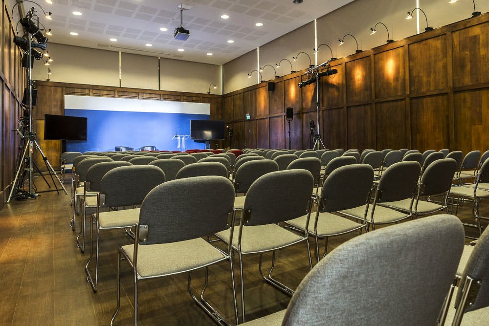 St Martins Hall event space with gray chairs, ideal for presentations and meetings.