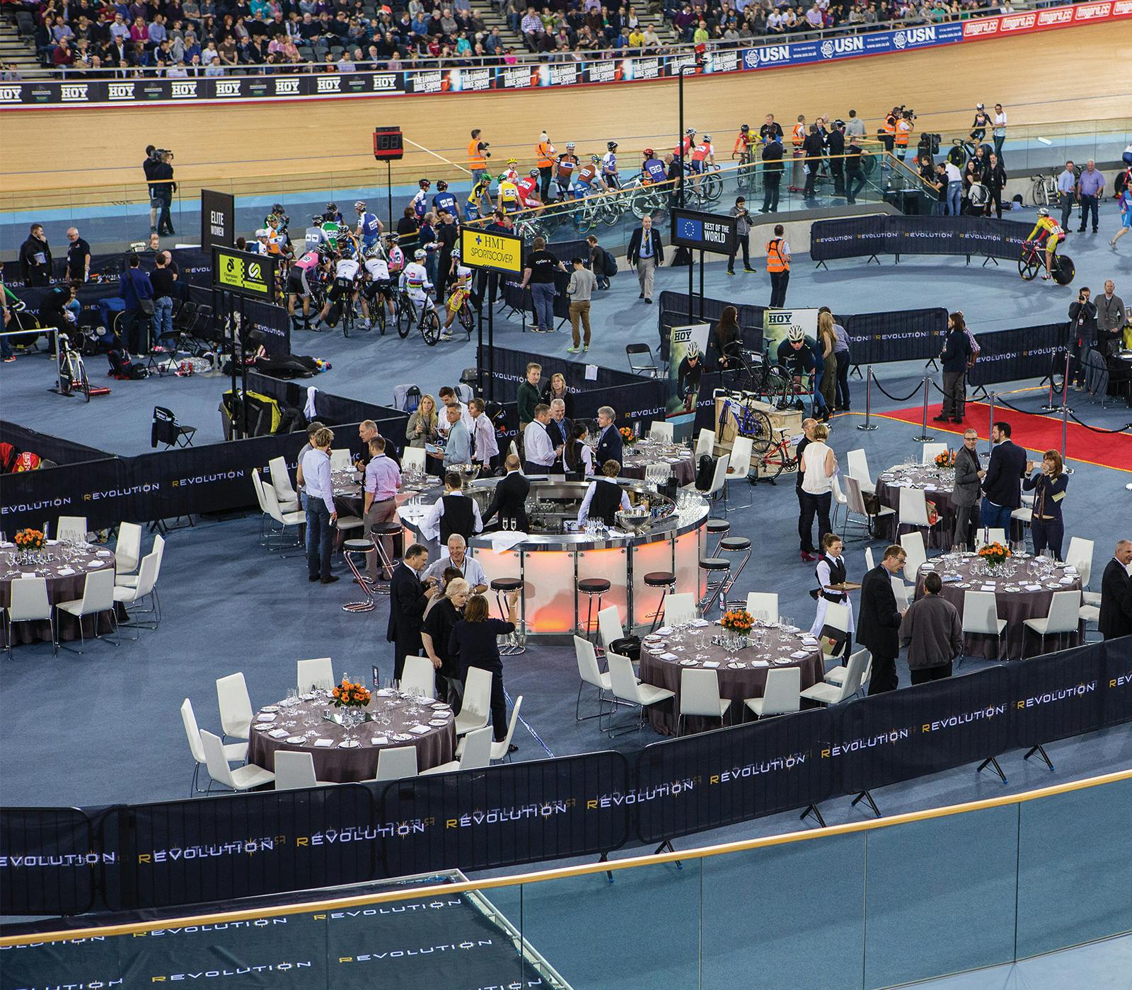 Velodrome Track Centre event setup with tables, cyclists, networking, and competition.