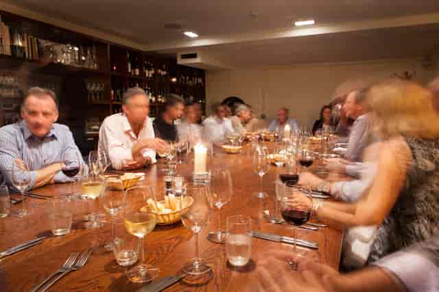Private dining room with communal table for corporate events and networking dinners.