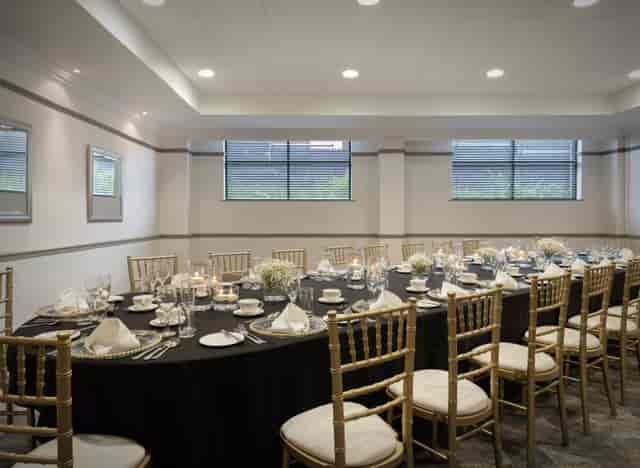 Hornby Room banquet setup with elegant black linens, ideal for corporate events and celebrations.