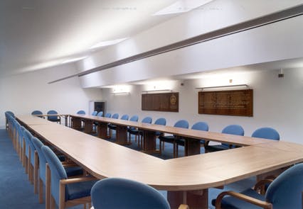 Modern conference room with elongated table and blue chairs for collaborative meetings.